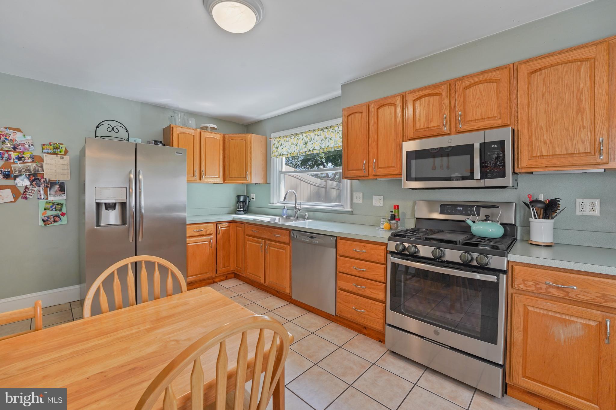 23 Waverly Road Havertown, PA 19083 - Photo 14 of 30 a kitchen with stainless steel appliances granite countertop a stove a sink dishwasher a microwave oven with granite countertops and cabinets