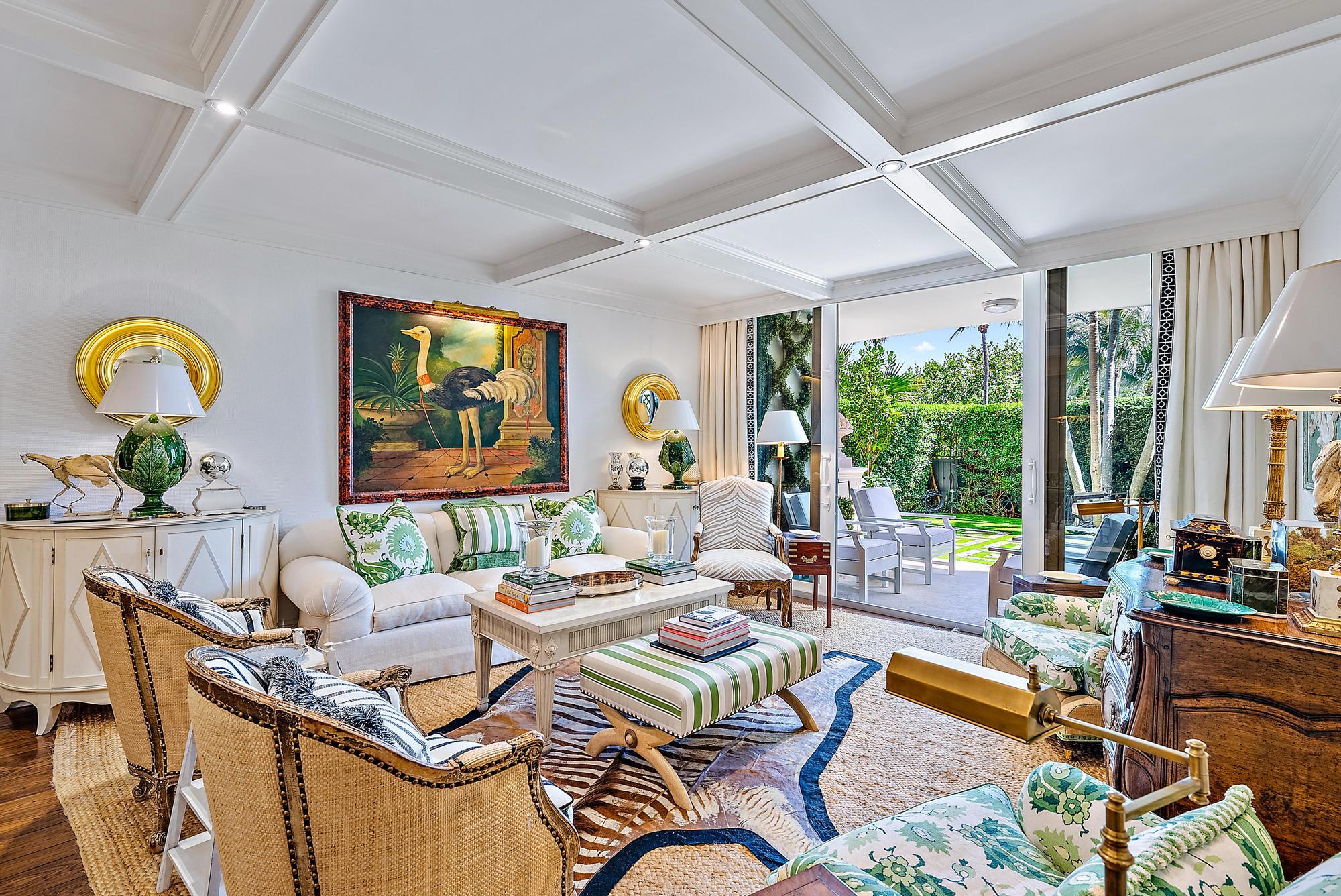 a living room with patio furniture and a floor to ceiling window