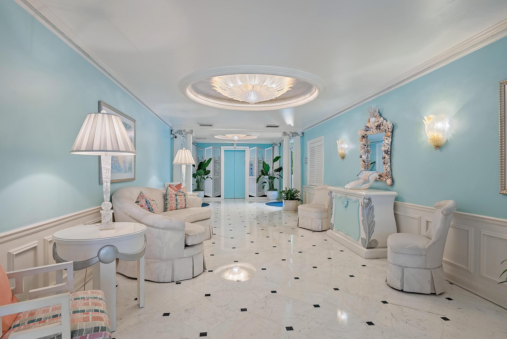 100 Royal Palm Way, Unit F1 Palm Beach, FL 33480 - Photo 34 of 43 a living room with furniture a lamp and a chandelier