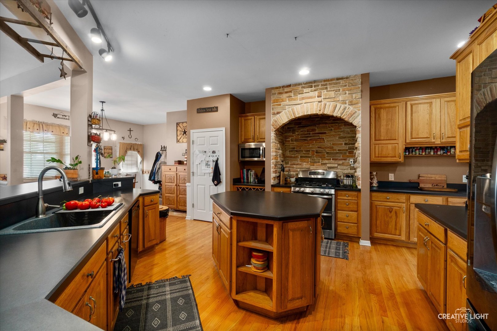 1750 Little Rock Road Plano, IL 60545 - Photo 11 of 33 a kitchen with stainless steel appliances granite countertop a stove a sink dishwasher and a refrigerator