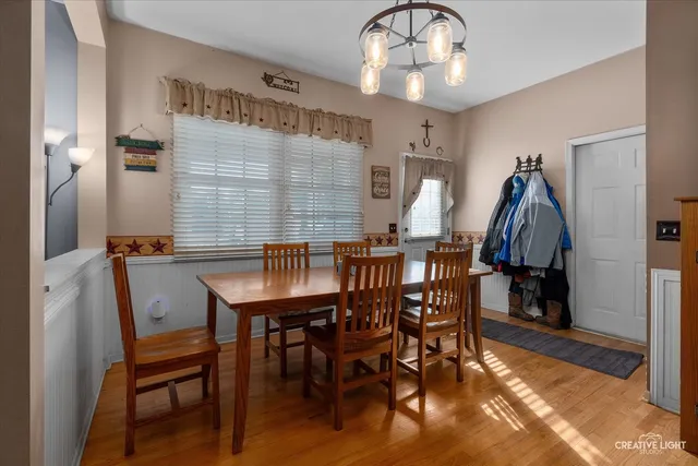 a view of a dining room with furniture and wooden floor