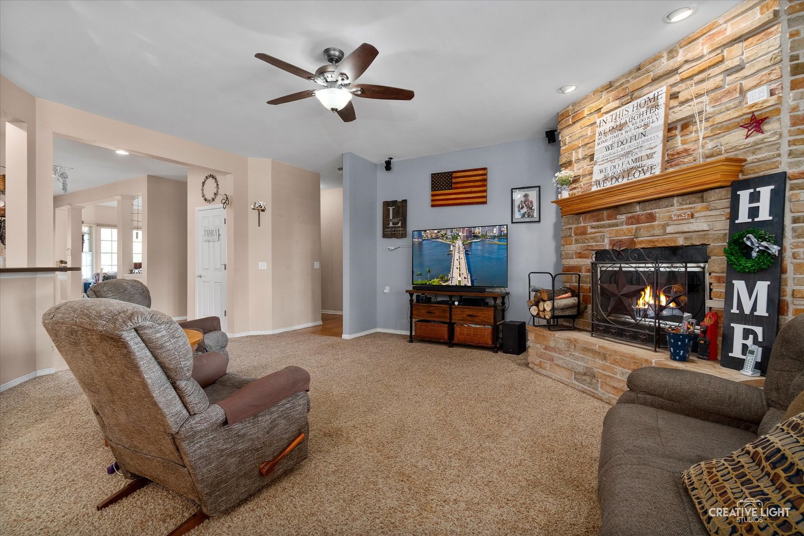 1750 Little Rock Road Plano, IL 60545 - Photo 17 of 33 a living room with furniture and a flat screen tv with kitchen view