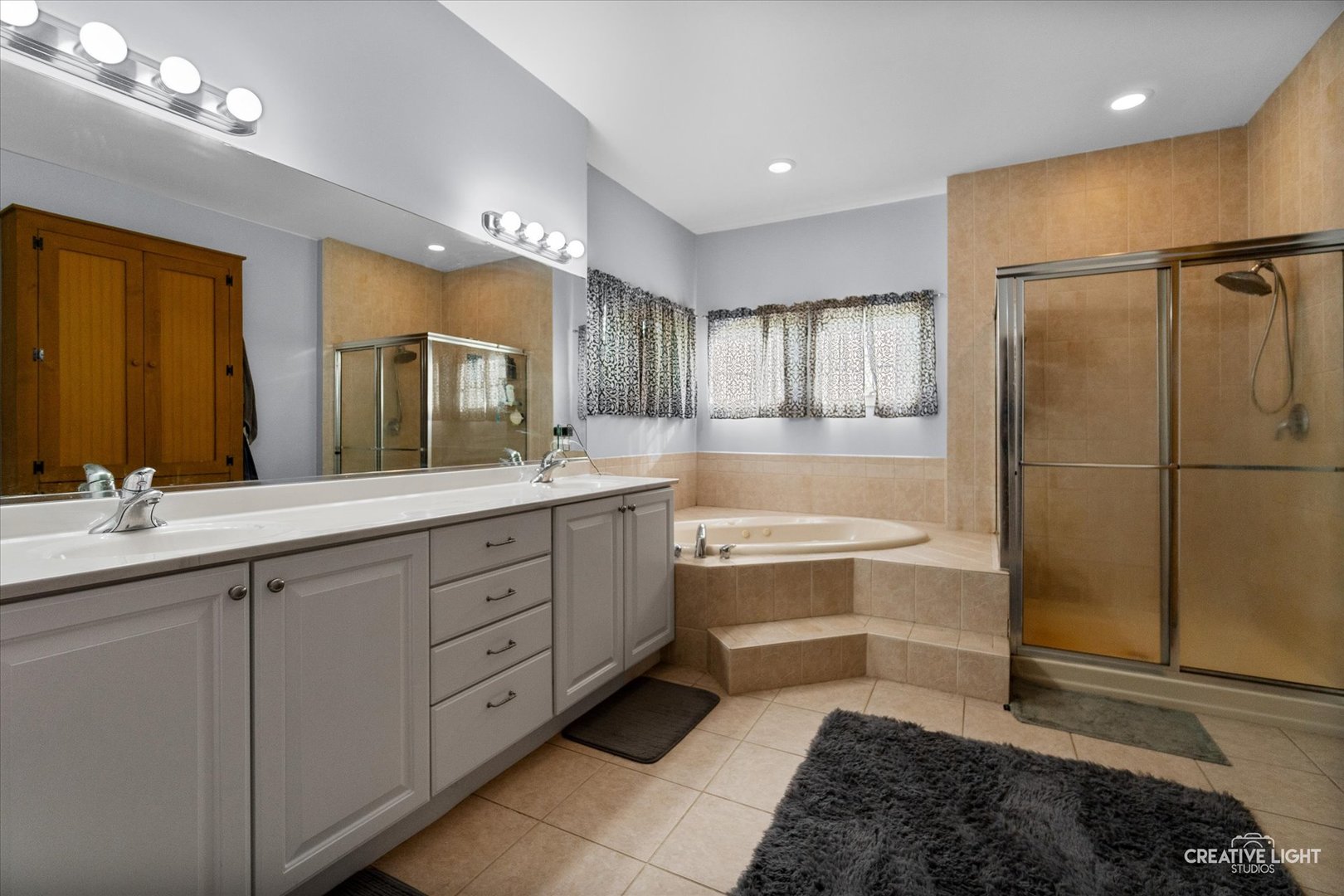 1750 Little Rock Road Plano, IL 60545 - Photo 19 of 33 a spacious bathroom with a tub sink and mirror
