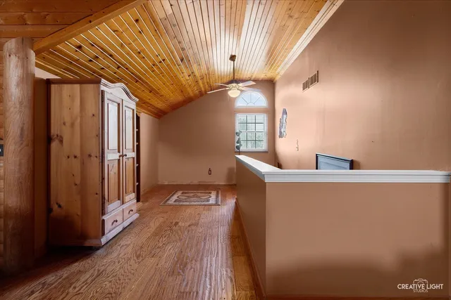 a very nice looking room with wooden floor and a window