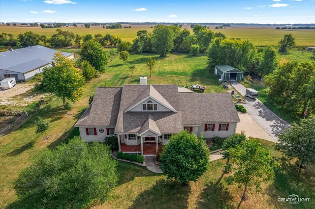 an aerial view of a house with big yard