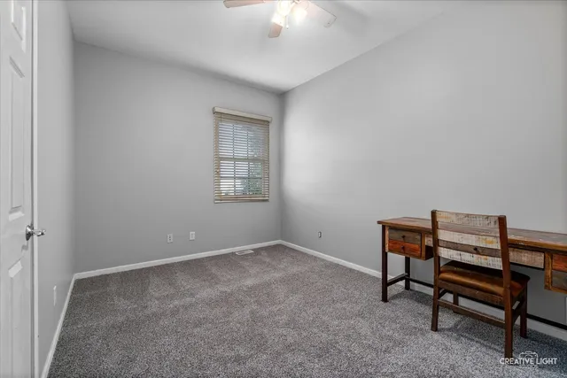 an empty room with a piano and wooden floor