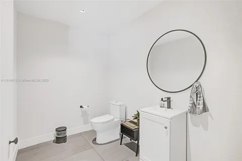 a bathroom with a toilet a sink a mirror and a shower