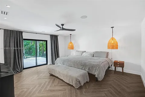 a bedroom with a bed couch and a window