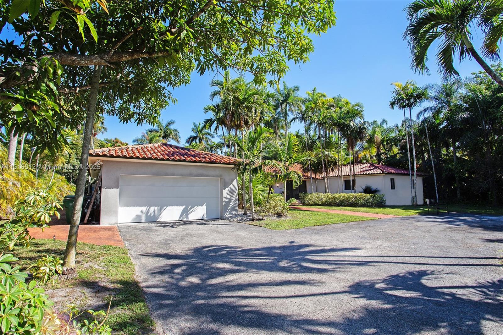 14135 North Miami Avenue Miami, FL 33168 - Photo 15 of 32 a front view of a house with a yard and garage