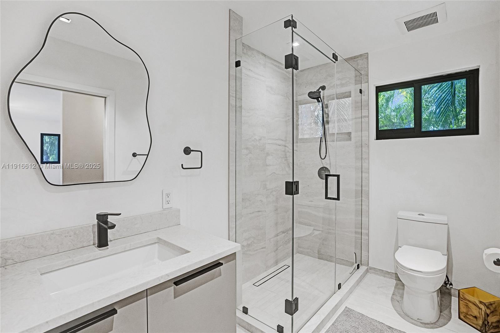 14135 North Miami Avenue Miami, FL 33168 - Photo 17 of 32 a bathroom with a sink a toilet and shower