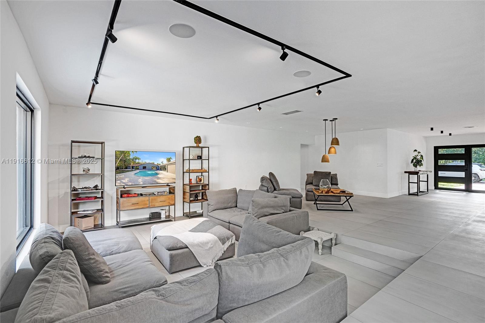 14135 North Miami Avenue Miami, FL 33168 - Photo 19 of 32 a living room with furniture and a large window
