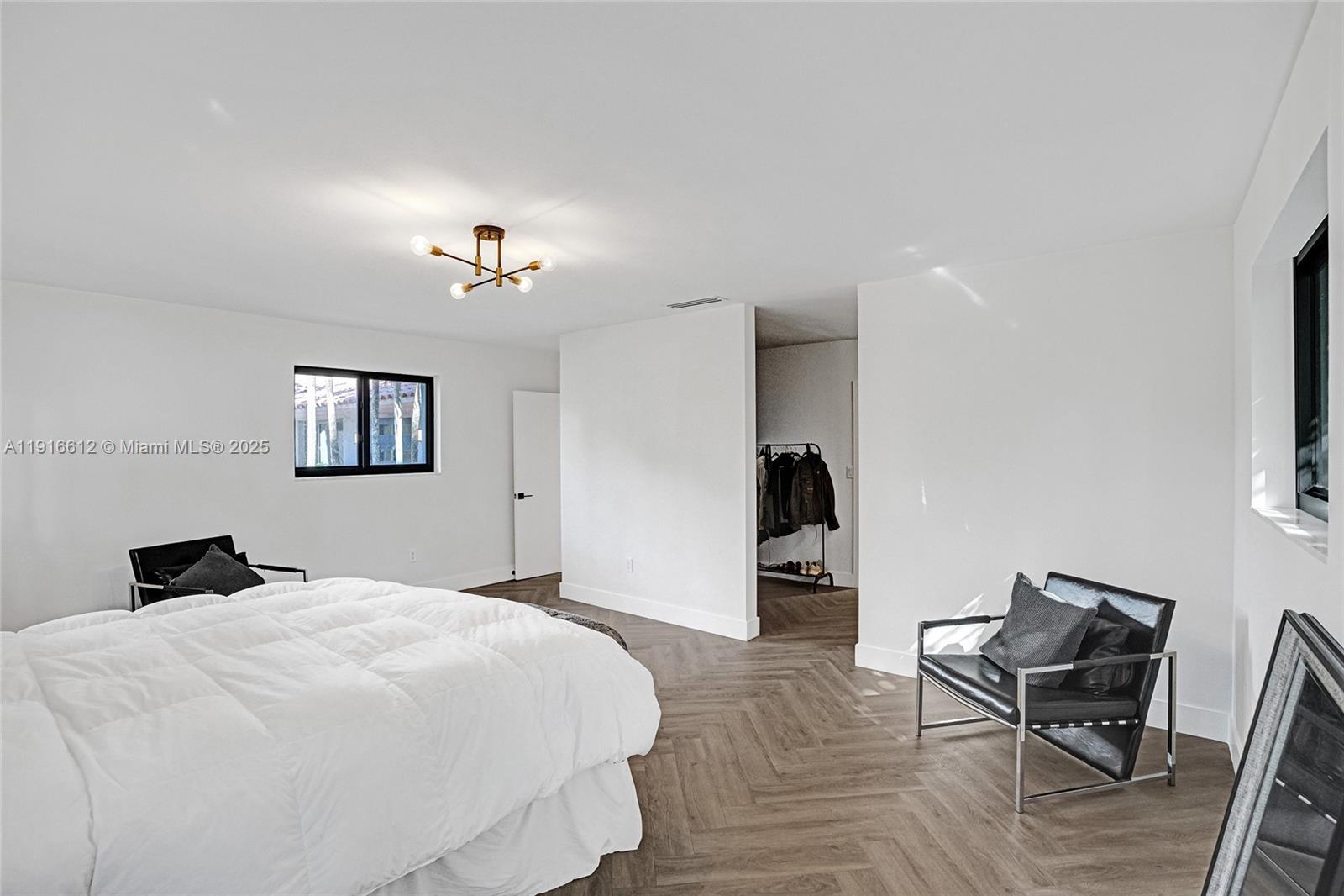 14135 North Miami Avenue Miami, FL 33168 - Photo 26 of 32 a bedroom with a bed and a table in it