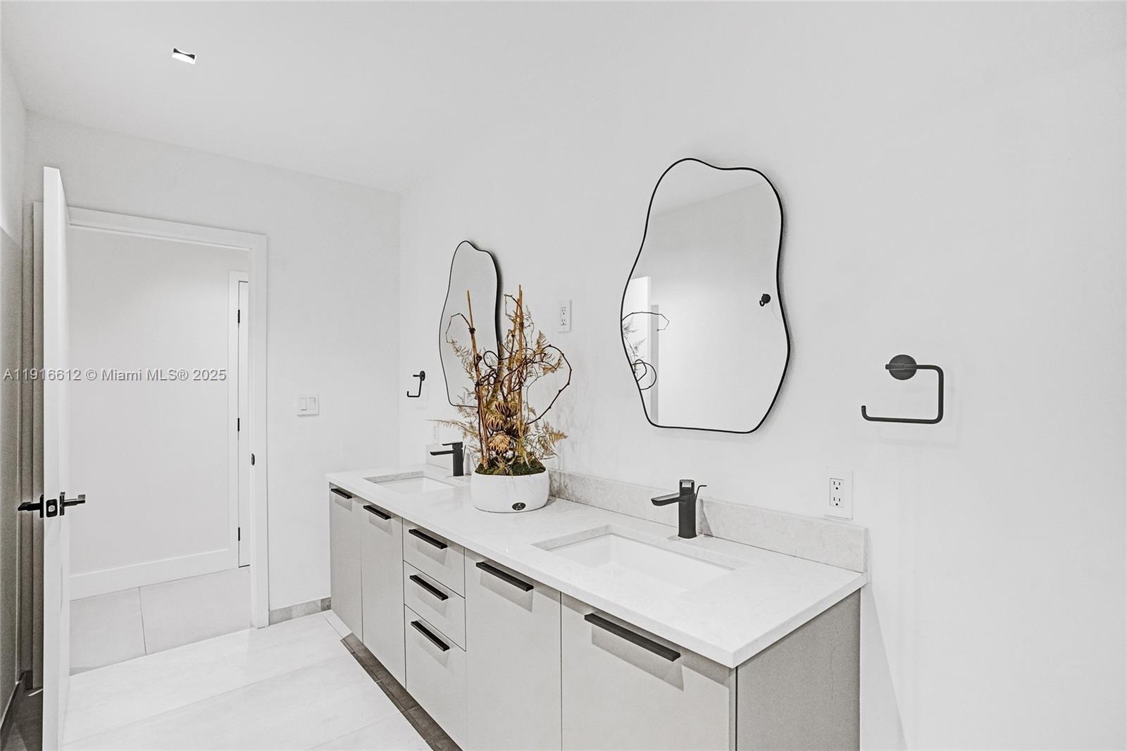14135 North Miami Avenue Miami, FL 33168 - Photo 27 of 32 a bathroom with a sink and a mirror