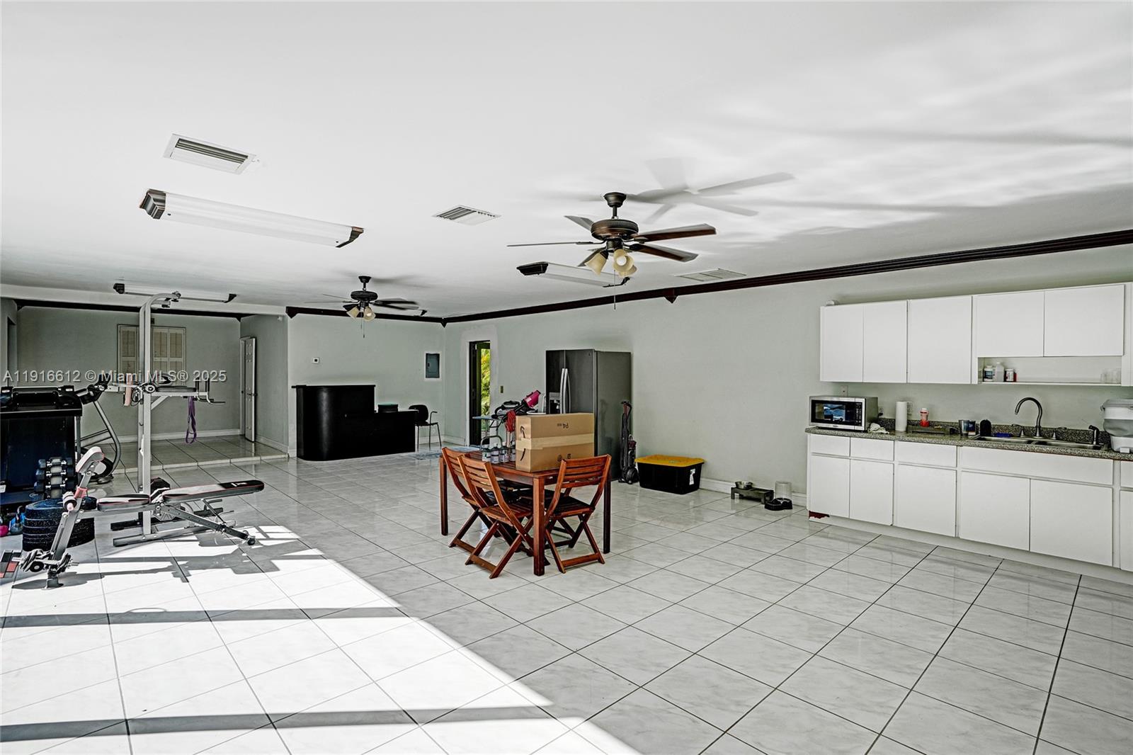 14135 North Miami Avenue Miami, FL 33168 - Photo 30 of 32 a living room with furniture a flat screen tv and kitchen view