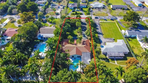 an aerial view of residential house with outdoor space and swimming pool