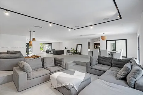 a living room with furniture and a ceiling fan