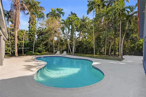 a view of a swimming pool with a patio