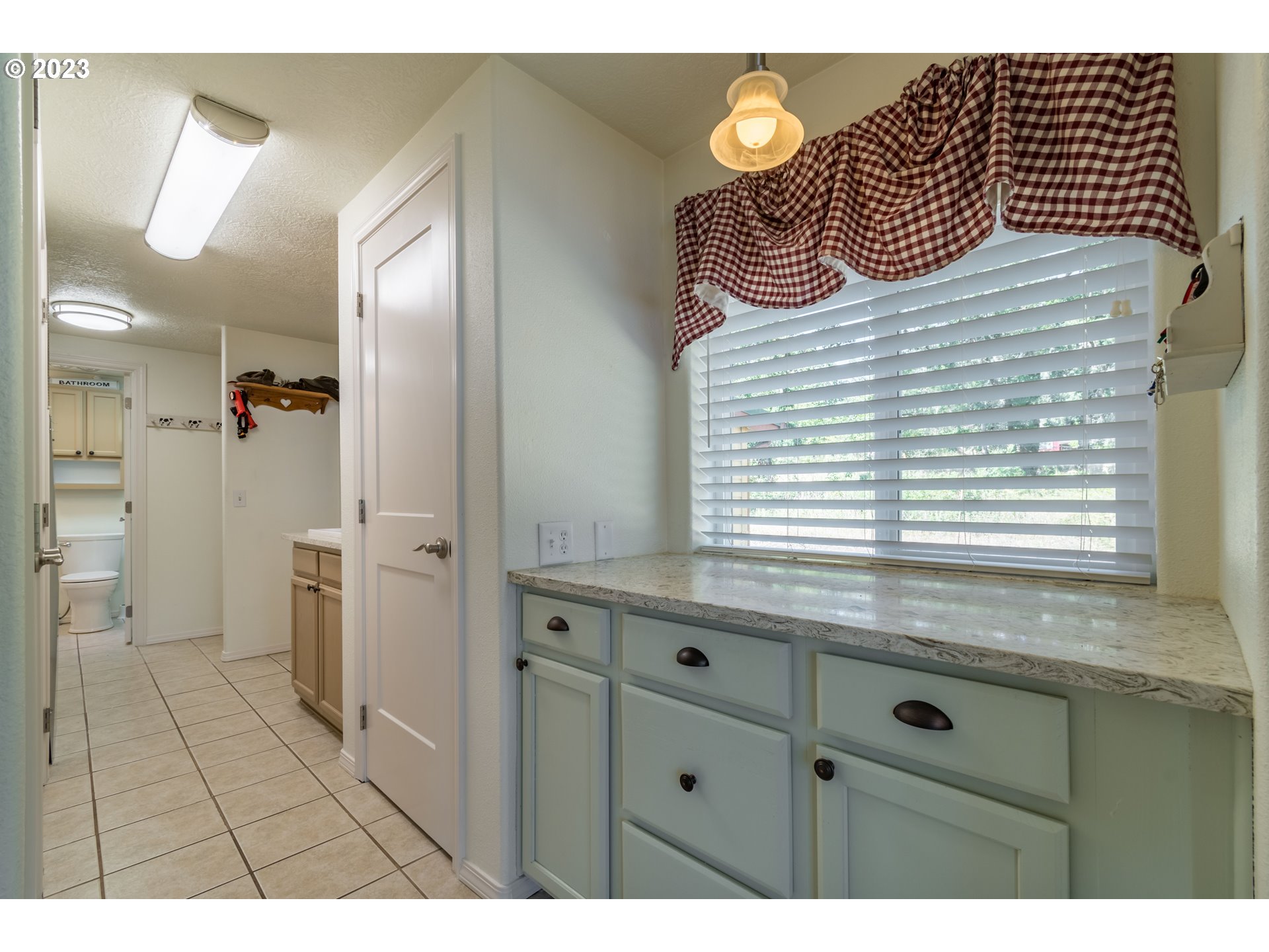 28485 Briggs Hill Road Eugene, OR 97405 - Photo 12 of 36 a view of a kitchen cabinets and a wooden floor