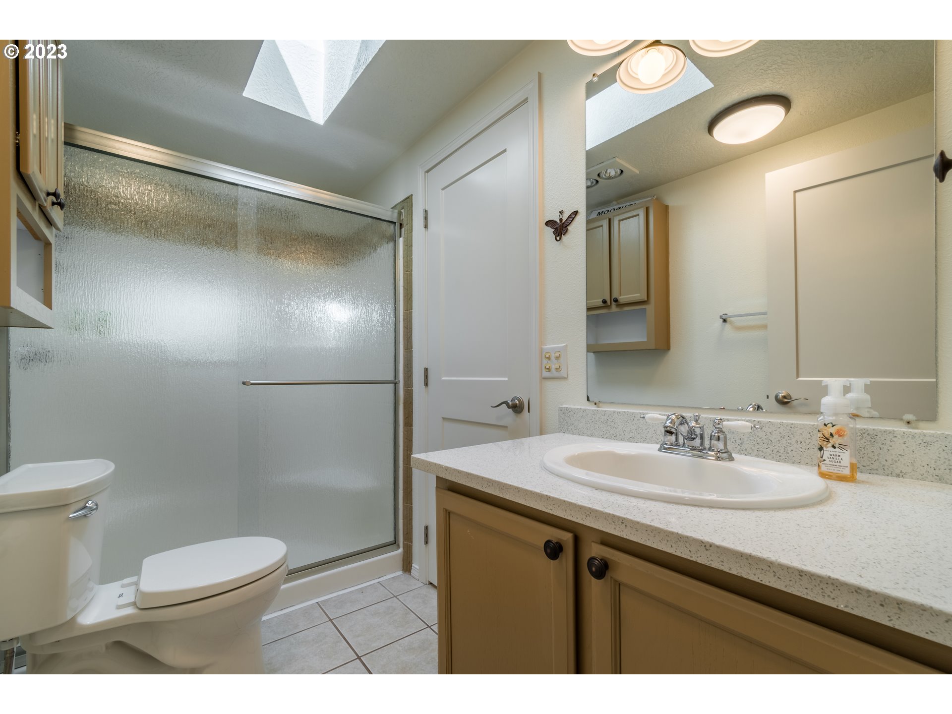 28485 Briggs Hill Road Eugene, OR 97405 - Photo 21 of 36 a bathroom with a sink a toilet a mirror and shower
