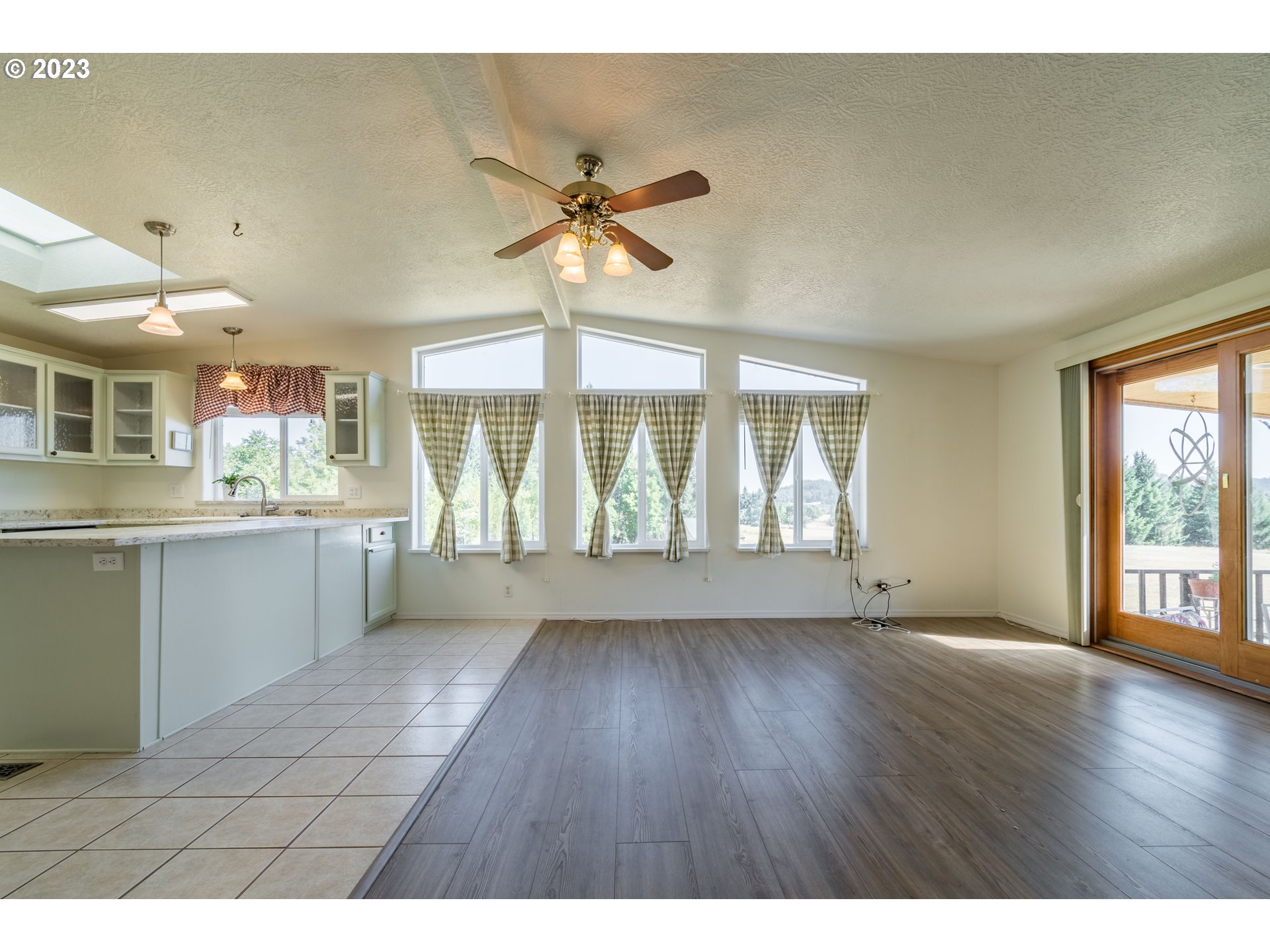 28485 Briggs Hill Road Eugene, OR 97405 - Photo 4 of 36 a view of an empty room with window and wooden floor