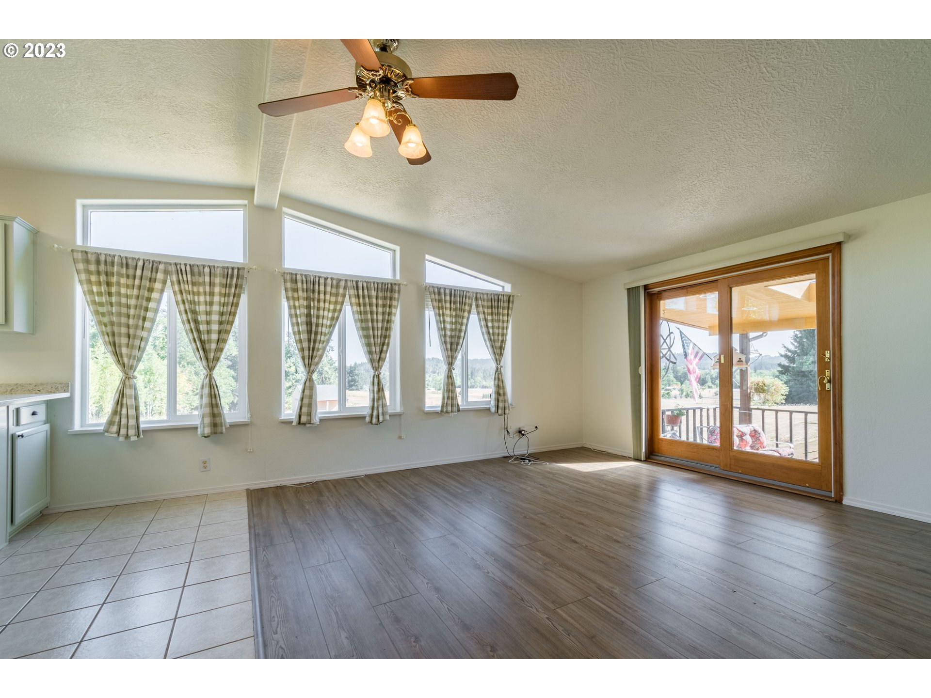 28485 Briggs Hill Road Eugene, OR 97405 - Photo 5 of 36 an empty room with wooden floor and windows