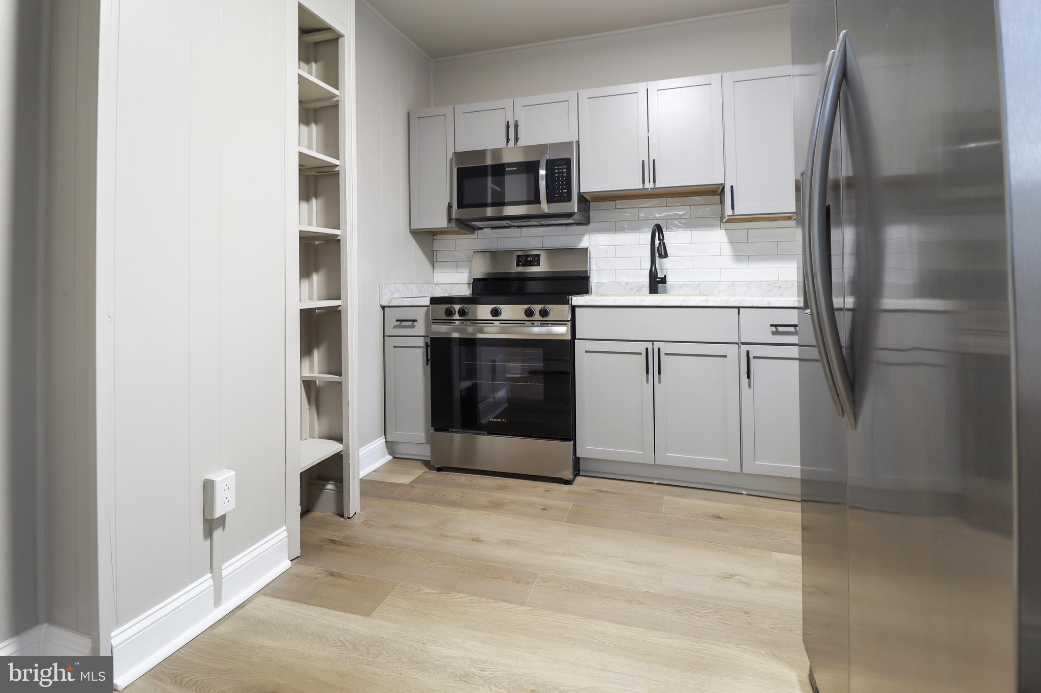 77 7th Street Salem, NJ 08079 - Photo 3 of 15 a kitchen with stainless steel appliances granite countertop a refrigerator stove and microwave