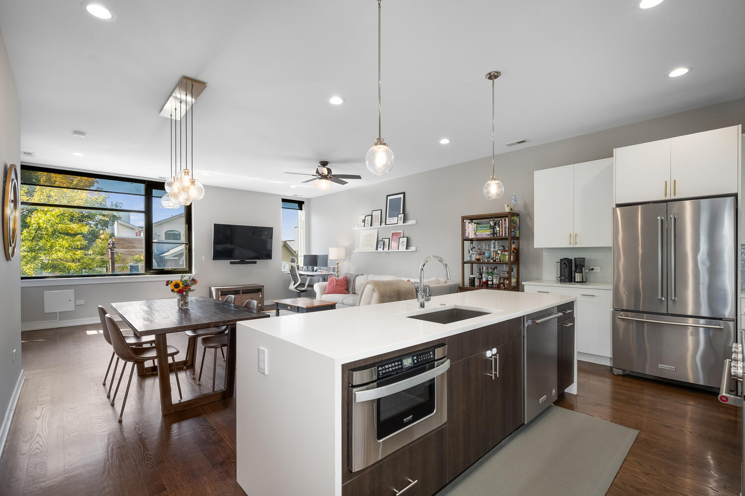 1841 North California Avenue, Unit 3B Chicago, IL 60647 - Photo 2 of 22 a kitchen with a sink stainless steel appliances and dining table