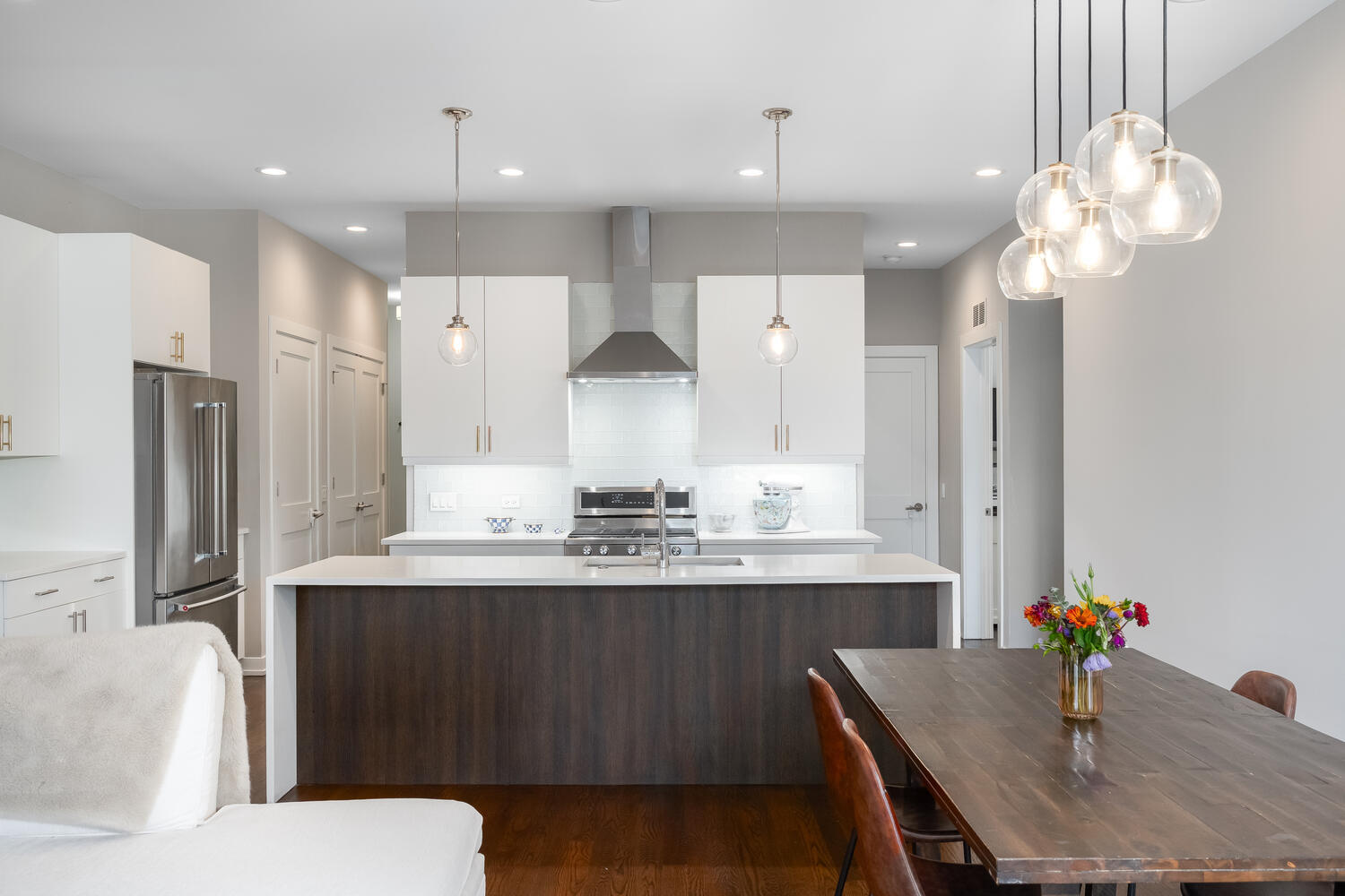 1841 North California Avenue, Unit 3B Chicago, IL 60647 - Photo 4 of 22 a kitchen with a table chairs sink and refrigerator