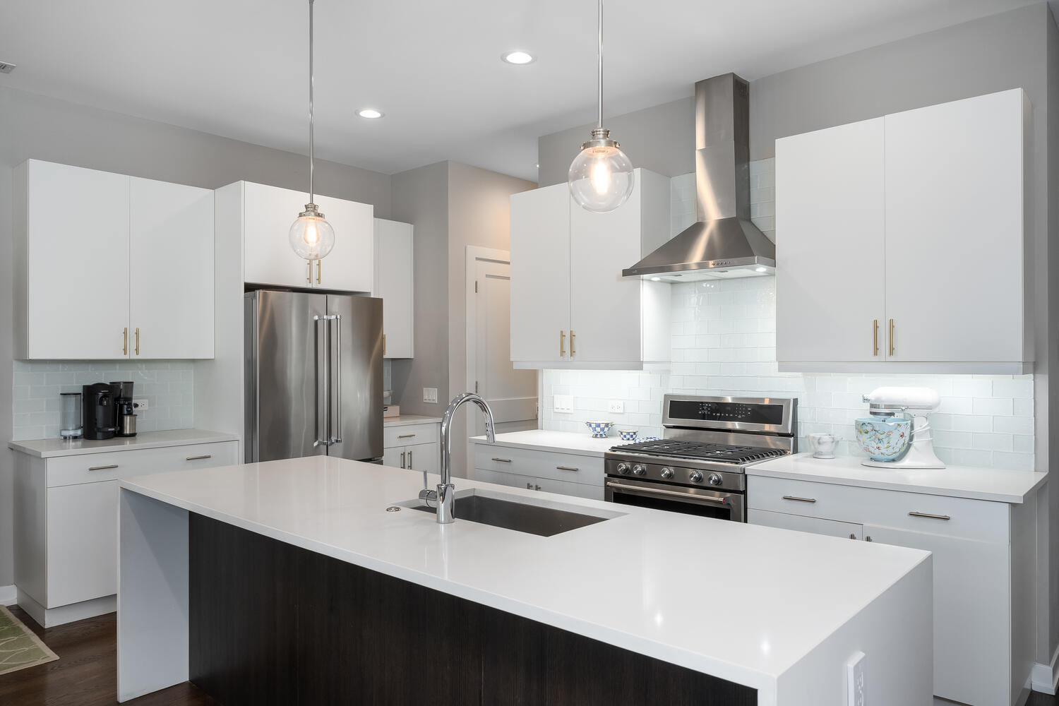 1841 North California Avenue, Unit 3B Chicago, IL 60647 - Photo 5 of 22 a kitchen with stainless steel appliances a sink a stove a refrigerator and chairs