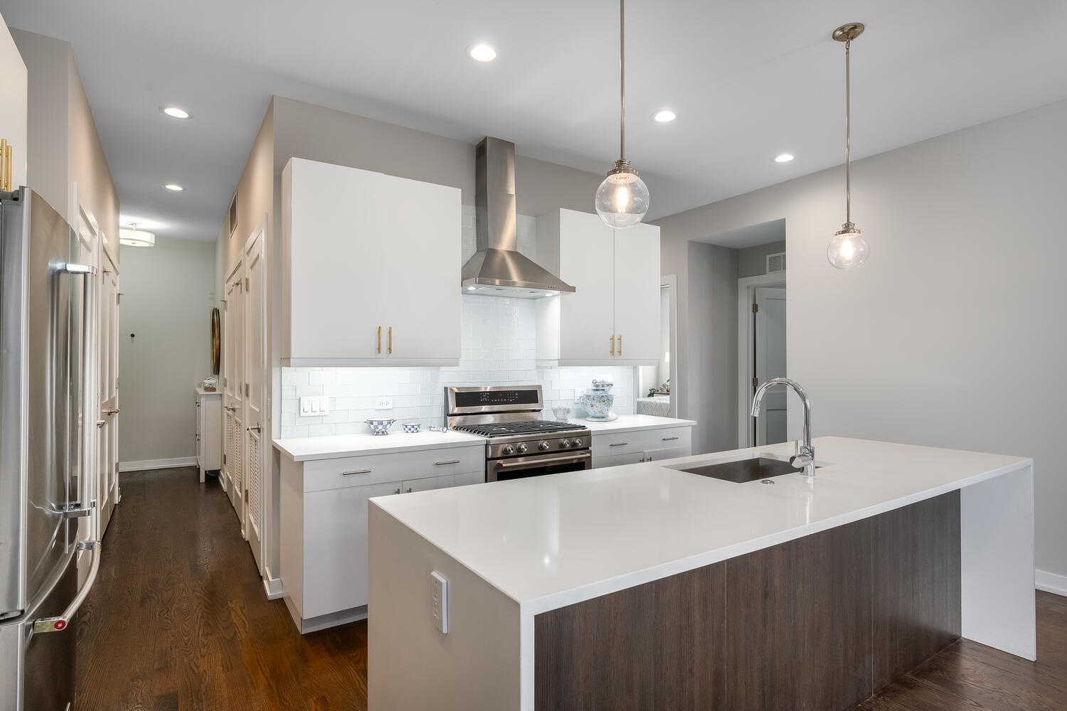 1841 North California Avenue, Unit 3B Chicago, IL 60647 - Photo 6 of 22 a kitchen with a stove a sink a refrigerator and chairs