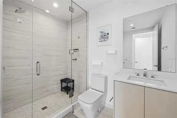 a bathroom with a sink toilet and shower