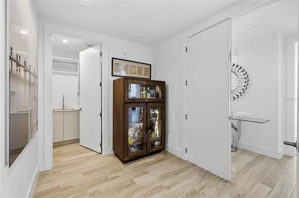 a view of a living room with furniture and floor to ceiling window