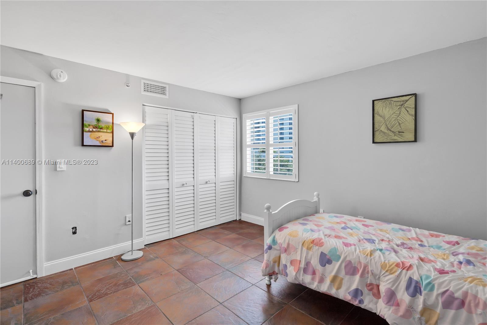 1401 Bay Road, Unit 411 Miami Beach, FL 33139 - Photo 23 of 37 a bedroom with a bed and a window