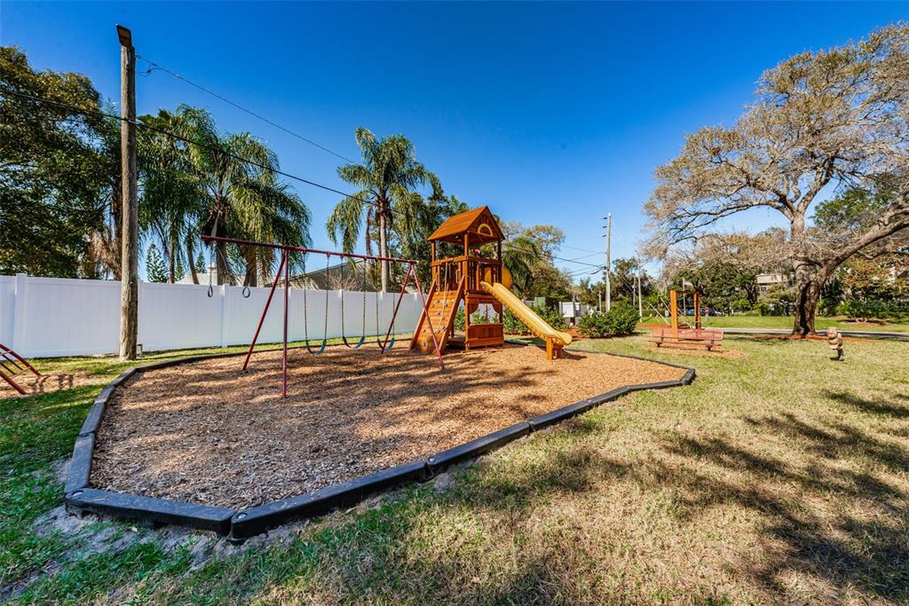 2407 Gun Flint Trail Palm Harbor, FL 34683 - Photo 30 of 43 a view of outdoor space with playground and tree
