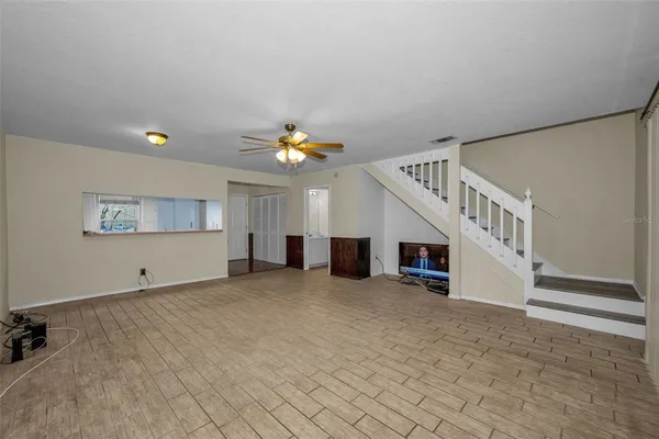 a view of a livingroom with a chandelier fan