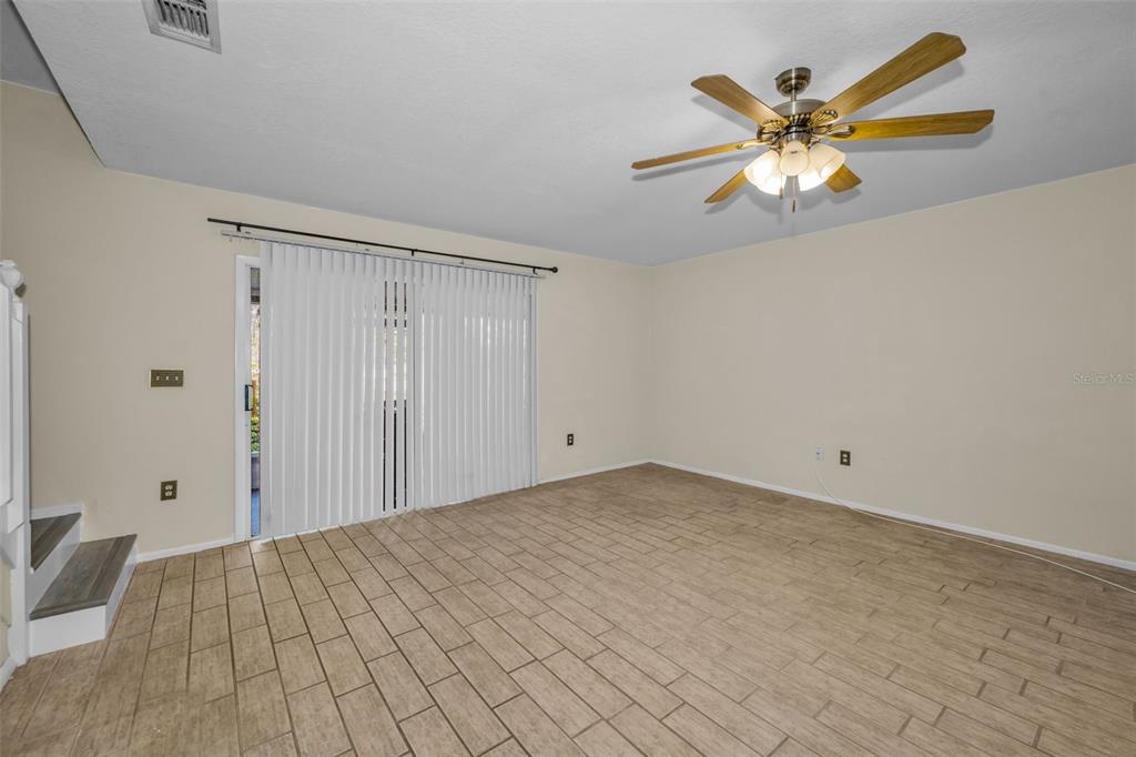 2407 Gun Flint Trail Palm Harbor, FL 34683 - Photo 7 of 43 a view of a livingroom with a chandelier fan