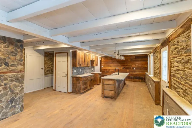 a spacious bathroom with a granite countertop sink and a large mirror