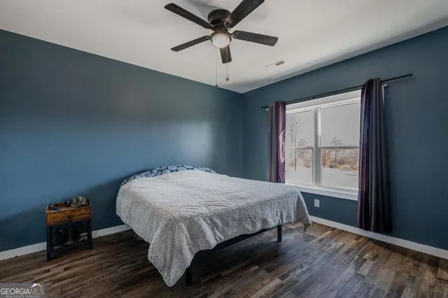 a bed sitting in a bedroom next to a window