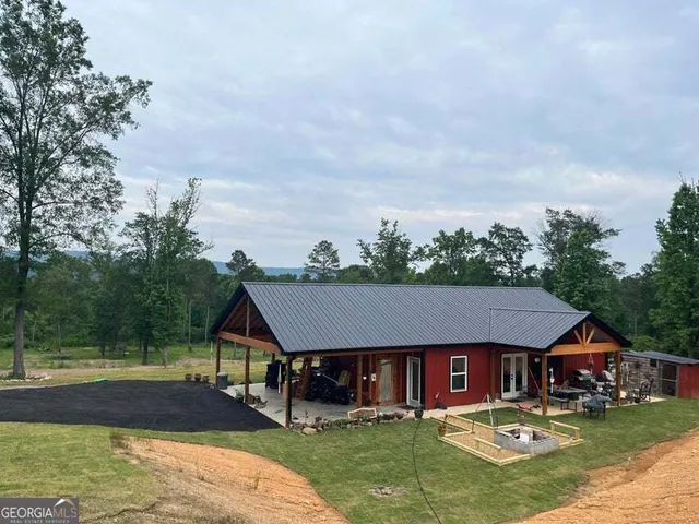 a aerial view of a house with swimming pool and big yard