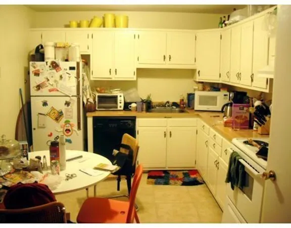 a kitchen with a sink appliances and cabinets