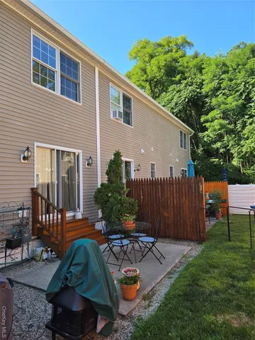 a view of a backyard with plants and a patio