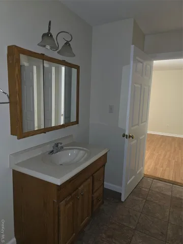a bathroom with a sink vanity and a mirror