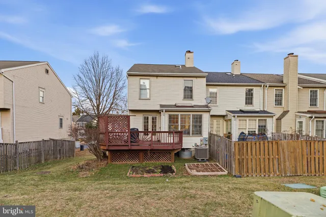 a view of a big house with wooden walls and a small yard
