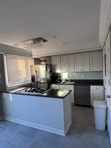 a kitchen with a sink and stove top oven