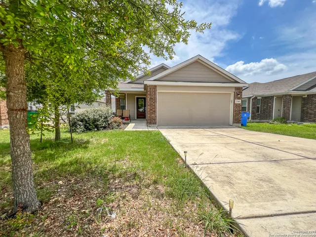 a front view of house with yard and green space
