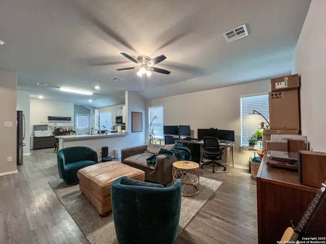 a living room with fireplace furniture and a flat screen tv