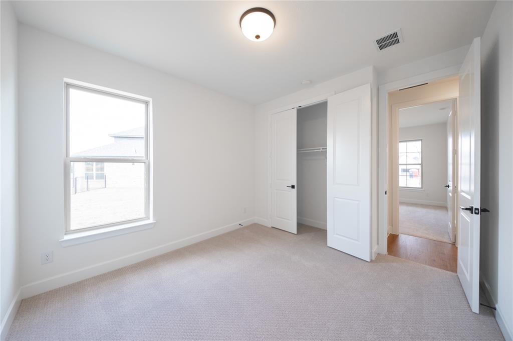 2715 Triumph Court Heath, TX 75126 - Photo 14 of 30 an empty room with windows and closet