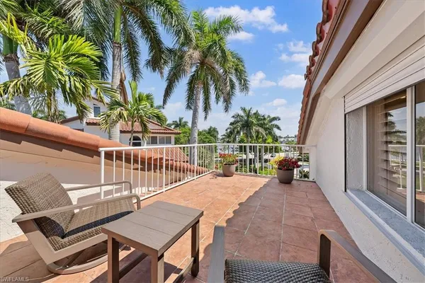 a view of a roof deck with chair and wooden floor