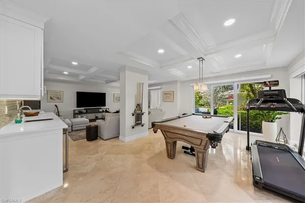 a room with furniture and potted plants