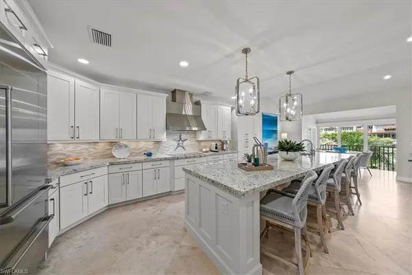 a kitchen with center island table and chairs in it